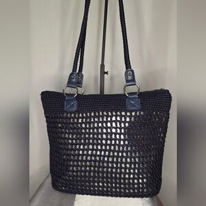 The Sak Navy Blue Hand-Crocheted Tote bag featuring a metallic gold underlay